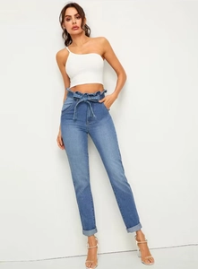 Detail of paper-bag high waist design with removable tie-belt on blue denim jeans