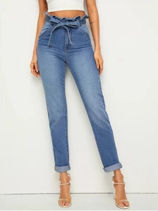 Detail of paper-bag high waist with tie belt on light blue stretch denim pants