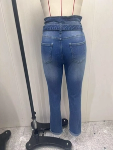 Detail view of high waist skinny denim jeans with back pockets and rolled hems