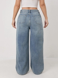 Rear view of light blue high-waisted wide-leg jeans with classic pockets and washed denim texture
