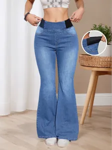 Detailed view of elastic side waistband on high waist blue flared jeans for women