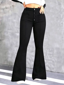 Close-up of black high-waisted flare jeans with button fly and large front patch pockets