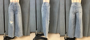 Front, side and back views of light blue wide-leg jeans with distressed knee details
