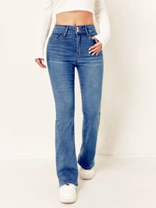 Detail of high waisted flared blue jeans with double buttons and washed denim texture