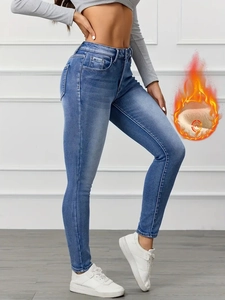Detail showing slim fit high waist jeans with thermal fleece lining for winter warmth