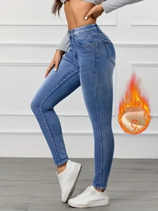 Detail of high waisted skinny jeans with thermal fleece lining and light blue wash