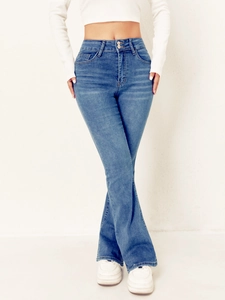 Detail of high waisted flare jeans featuring a trendy double-button closure and slim fit design