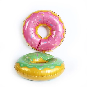 Pink and green donut-shaped foil balloons with colorful sprinkle patterns for party decor