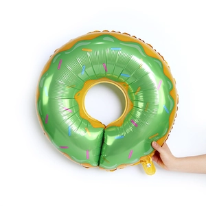 Large donut foil balloon in green and gold finish for birthday party wall decoration