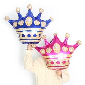 Detail of blue and pink crown foil balloons with golden polka dots for party decor