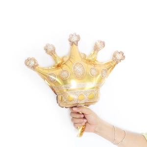 Large golden crown foil balloon with glitter texture and white dots for party decor
