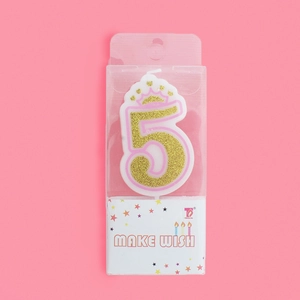 Detail of pink and gold number 5 birthday candle with crown and glitter in retail box