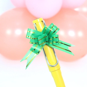 Yellow fountain pen with silver metal clip and green gold-edged bow ribbon decoration