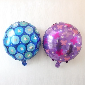 Detail of round foil balloons with star and butterfly patterns for party decoration