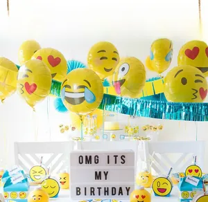 Detailed setup of vibrant emoji foil balloons for birthday party room decoration
