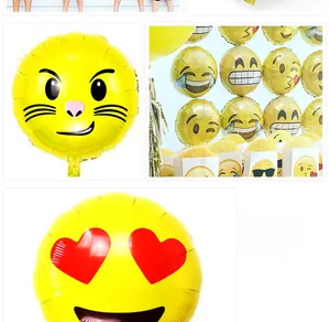 Detail of yellow round emoji foil balloons featuring various fun facial expressions