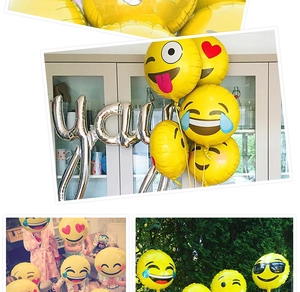Detail view of emoji foil balloons for birthday party decor including silver YAY letters