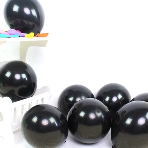 Glossy 10-inch black latex balloons for party decoration displayed on a white stand