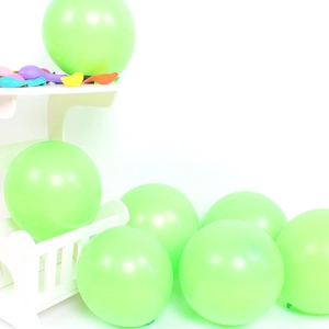 Detail of matte green latex balloons on white display stand for party arch decorations