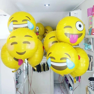 Variety of yellow Emoji foil balloons for party decorations and birthday celebrations