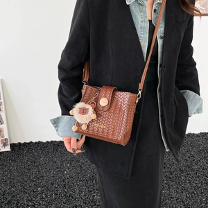 Vintage brown woven leather bucket bag with wide strap and cute sheep pendant