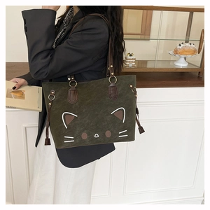 Close-up of green cat tote bag with cute embroidery and side drawstring detail