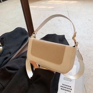 Close-up of color-block square bag with khaki textured fabric and gold hardware