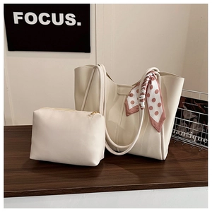 Close-up of cream-white tote bag set with polka dot silk scarf and small pouch detail