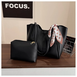 Detail of black leather tote bag set with matching pouch and pink polka dot scarf