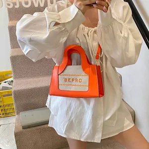 Chic orange leather and canvas tote bag with BEPRO logo for elegant crossbody wear