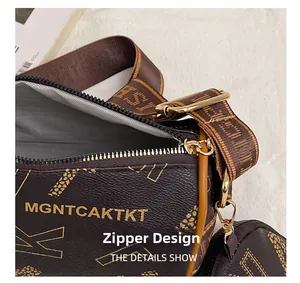 Detail view of the top zipper closure and logo patterned wide textile shoulder strap