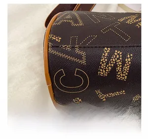 Macro detail of high-quality stitching on brown Boston bag with letter print pattern