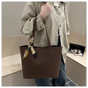 Large leopard print tote bag with decorative silk scarf shown on shoulder for daily use