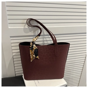 Detail of burgundy leopard print tote bag with decorative vintage pattern silk scarf
