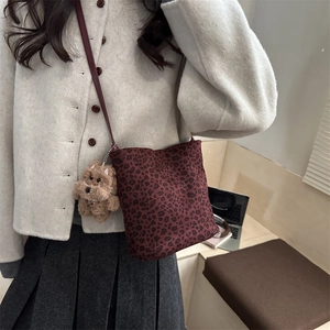 Retro leopard print bucket bag in burgundy with a cute brown teddy bear charm