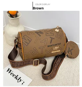 Detail of a brown Boston bag with monogram leather, coin purse and wide logo strap