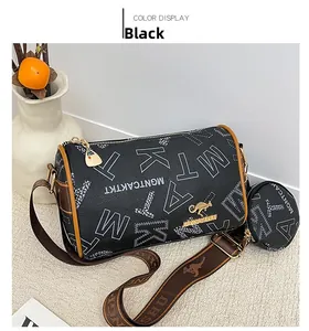 Detail of black Boston bag featuring letter prints and a wide jacquard kangaroo strap