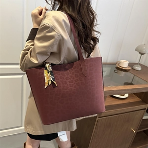 Large leopard print tote bag in burgundy leather with a decorative silk scarf