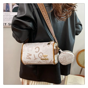 Close-up of white leather cylinder bag with brown art patterns and mini coin pouch detail