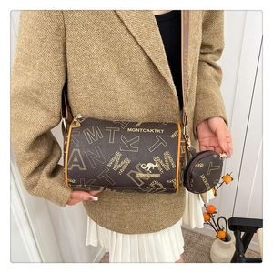 Detail of dark brown leather Boston bag with pattern print and small round coin purse