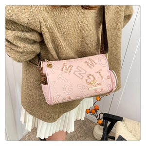 Detail of pink Boston bag featuring kangaroo metal logo and wide branded shoulder strap