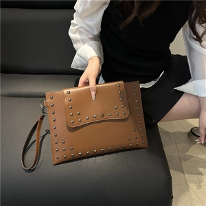 Brown leather clutch bag with silver metal studs and detachable wrist strap for women