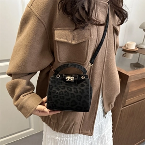 Stylish black leopard print crossbody bag with gold twist lock for casual spring fashion