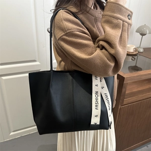 Fashionable black PU tote bag for women with minimalist white strap detailing