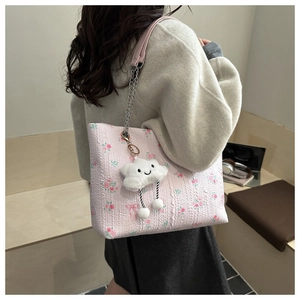 Pink floral tote bag detail with metal chain strap and white cloud plush charm detail