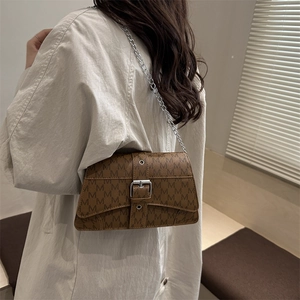 Brown monogram crossbody bag with M print and silver chain strap shown on model