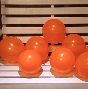 Bunch of seven inflated round orange latex balloons for Halloween party decoration