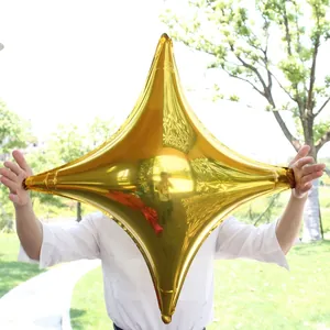 Outdoor shot of a shiny gold star-shaped foil balloon with reflective metallic finish