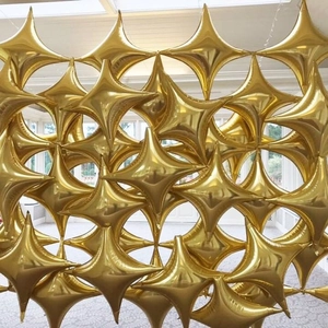 36-inch gold star-shaped foil balloons creating a decorative wall for party and wedding venues