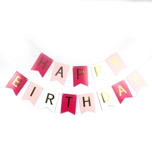 Detail of pink and white swallowtail Happy Birthday banner with gold foil letters